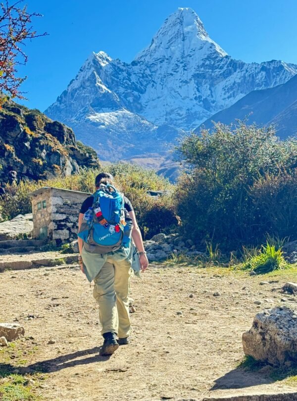 Mt. Ama Dablam view with a tourist enjoying the trek.