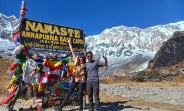 Trekkers at Annapurna Base Camp (4,130m) during the 7 Days Annapurna Base Camp Trek, surrounded by stunning Himalayan peaks.