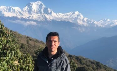 Traveler with Dhaulagiri Mountain in the background from Poon Hill, Nepal