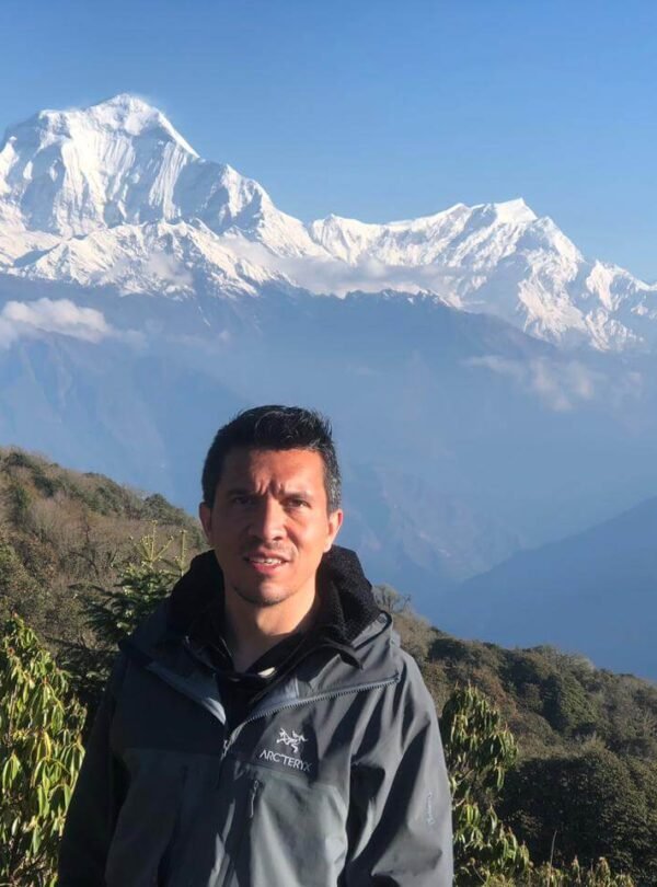 Traveler with Dhaulagiri Mountain in the background from Poon Hill, Nepal