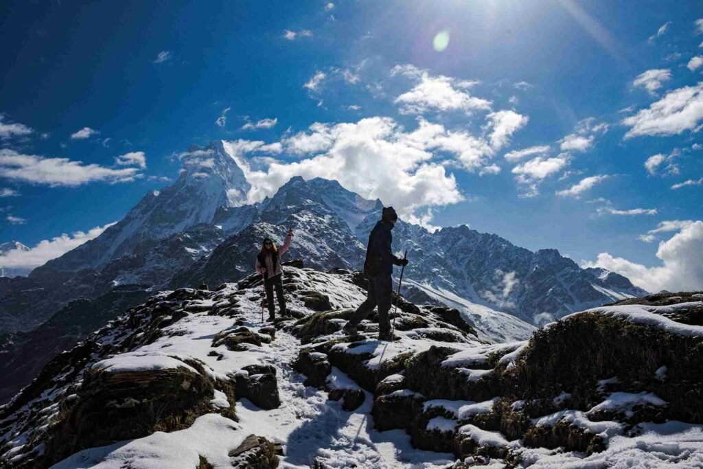 Trekking through snow-covered trails on the Mardi Himal Trek with a stunning view of Mt. Fishtail (Machhapuchhre) in Nepal.