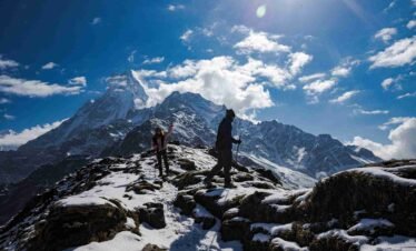 Trekking through snow-covered trails on the Mardi Himal Trek with a stunning view of Mt. Fishtail (Machhapuchhre) in Nepal.