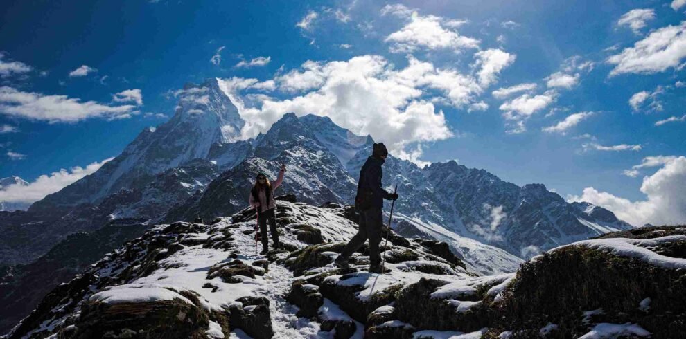 Trekking through snow-covered trails on the Mardi Himal Trek with a stunning view of Mt. Fishtail (Machhapuchhre) in Nepal.