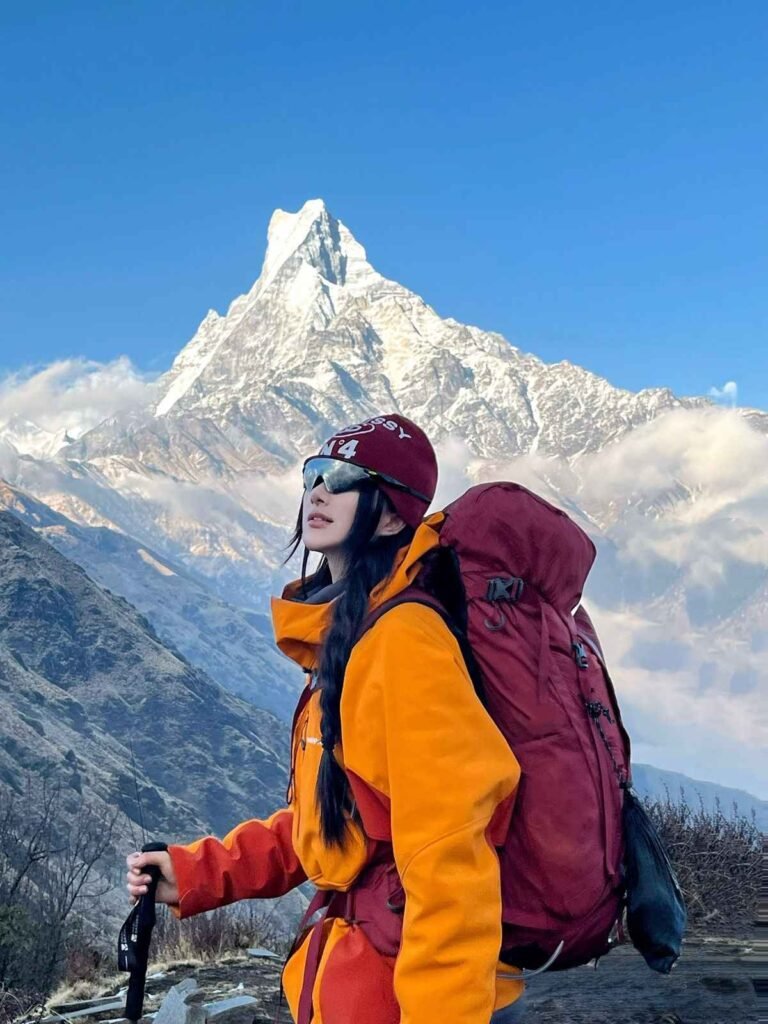 Mardi Himal Trek Nepal with Machhapuchhre view female trekker on scenic ridge trail near High Camp