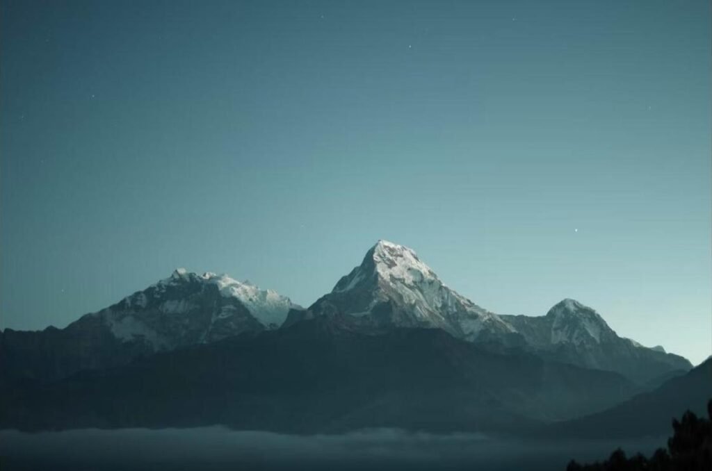 Everest Scenic Flight view of Himalayan peaks at dawn beneath a star-filled sky