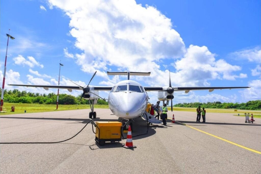 Everest Scenic Flight twin-propeller aircraft on the tarmac with ground crew before departure
